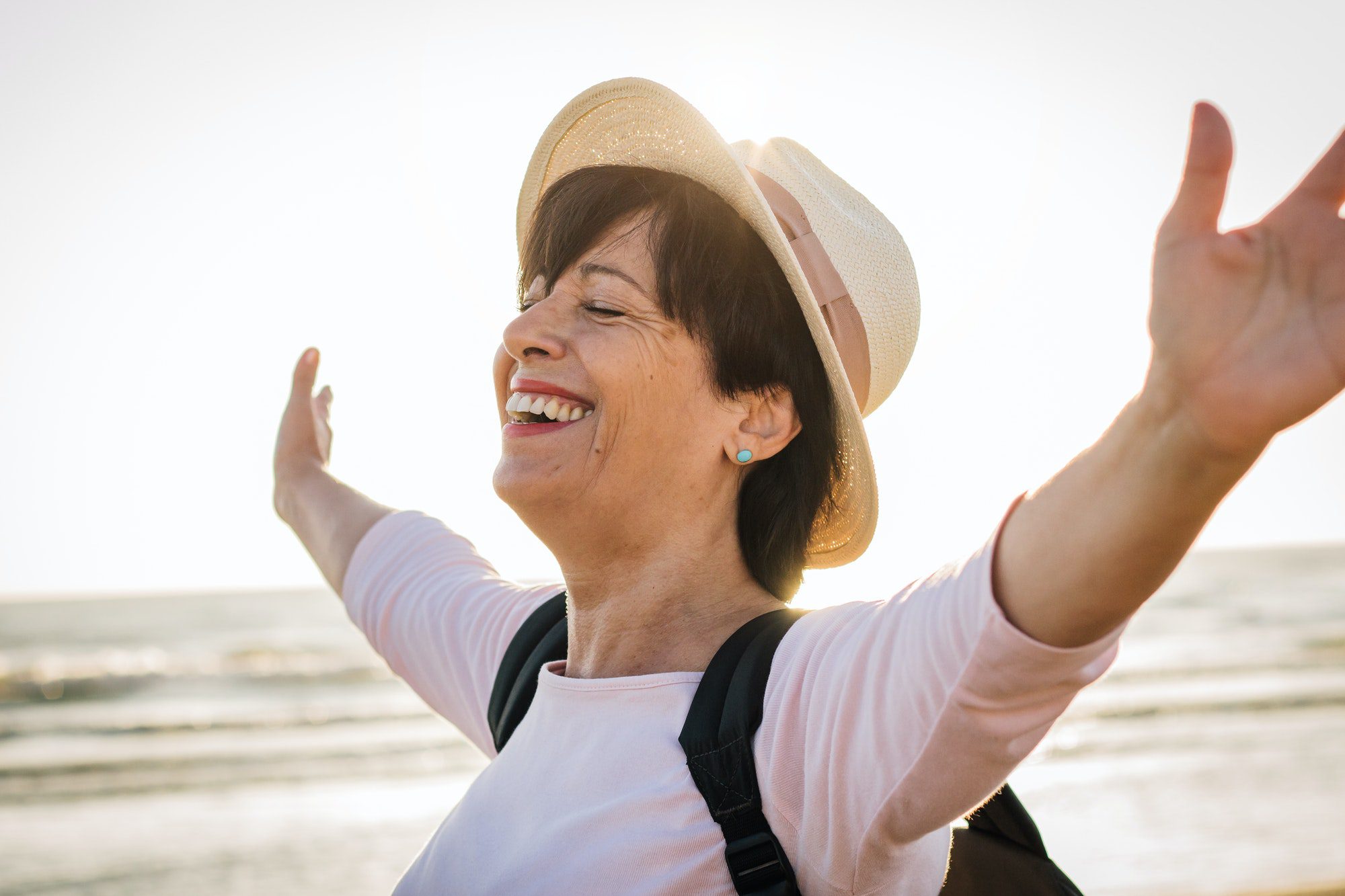 Happy senior woman on the beach knowing that her insulin cost is drastically lower.