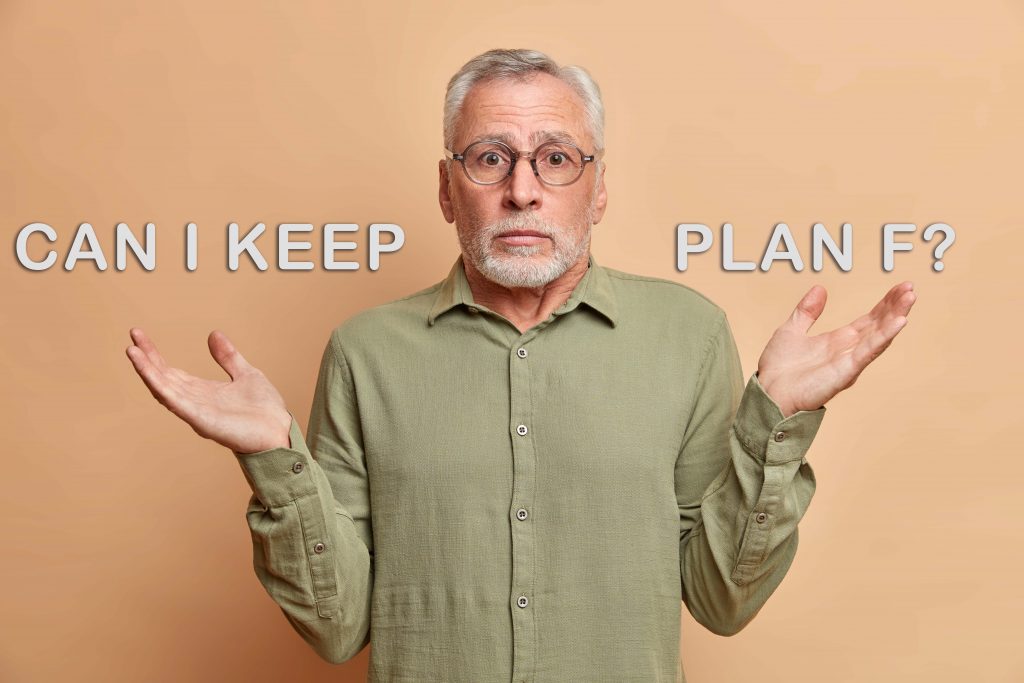 Senior man shrugging his shoulders while asking if he can keep his plan f medicare.