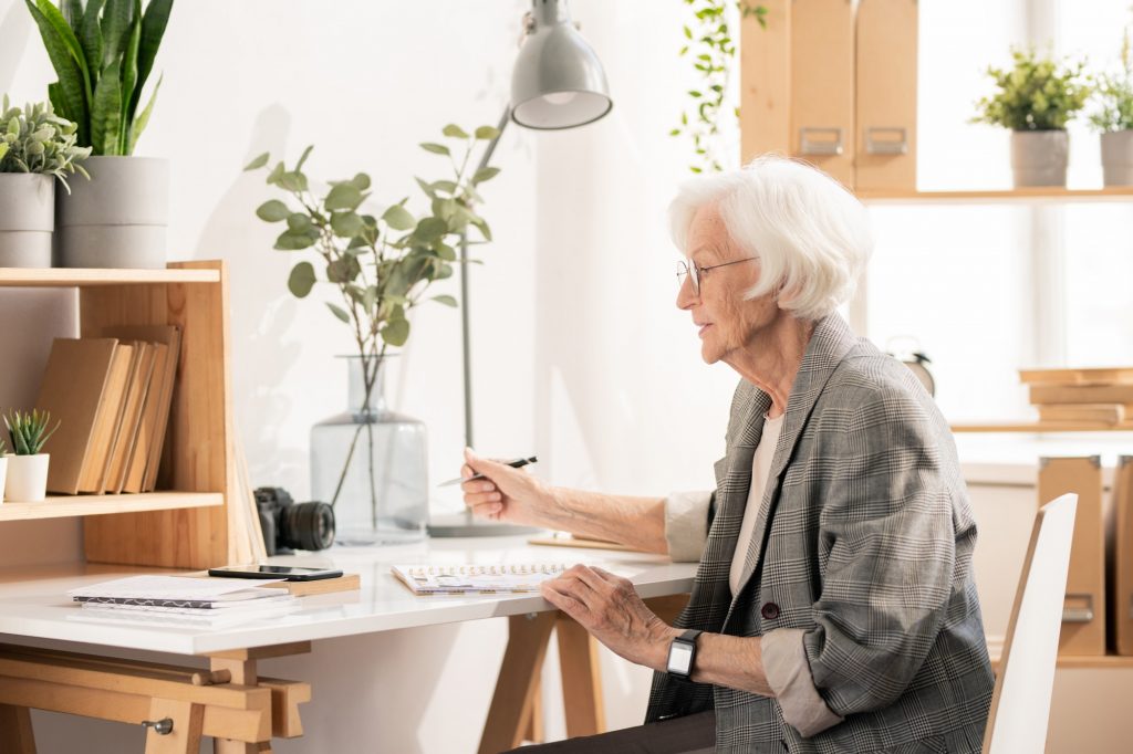 Senior lady going over medicare paperwork about applying for Medicare Part B.
