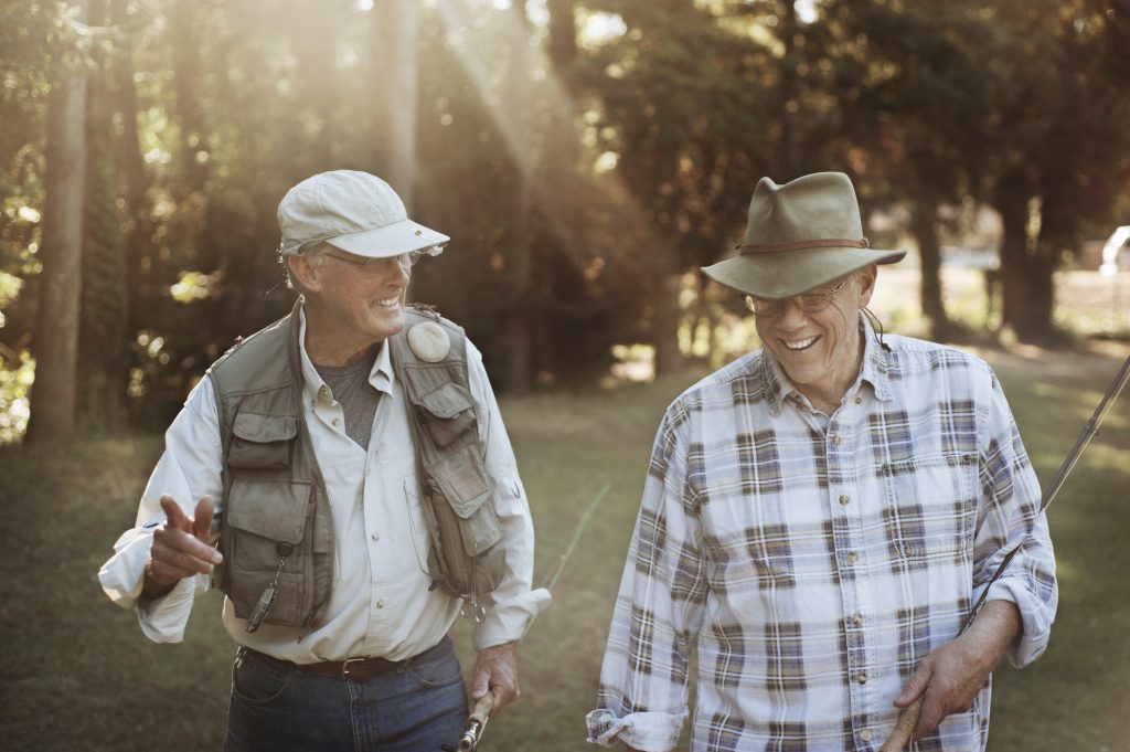 Senior men enjoying fishing as they discuss Medicare Part C eligibility.