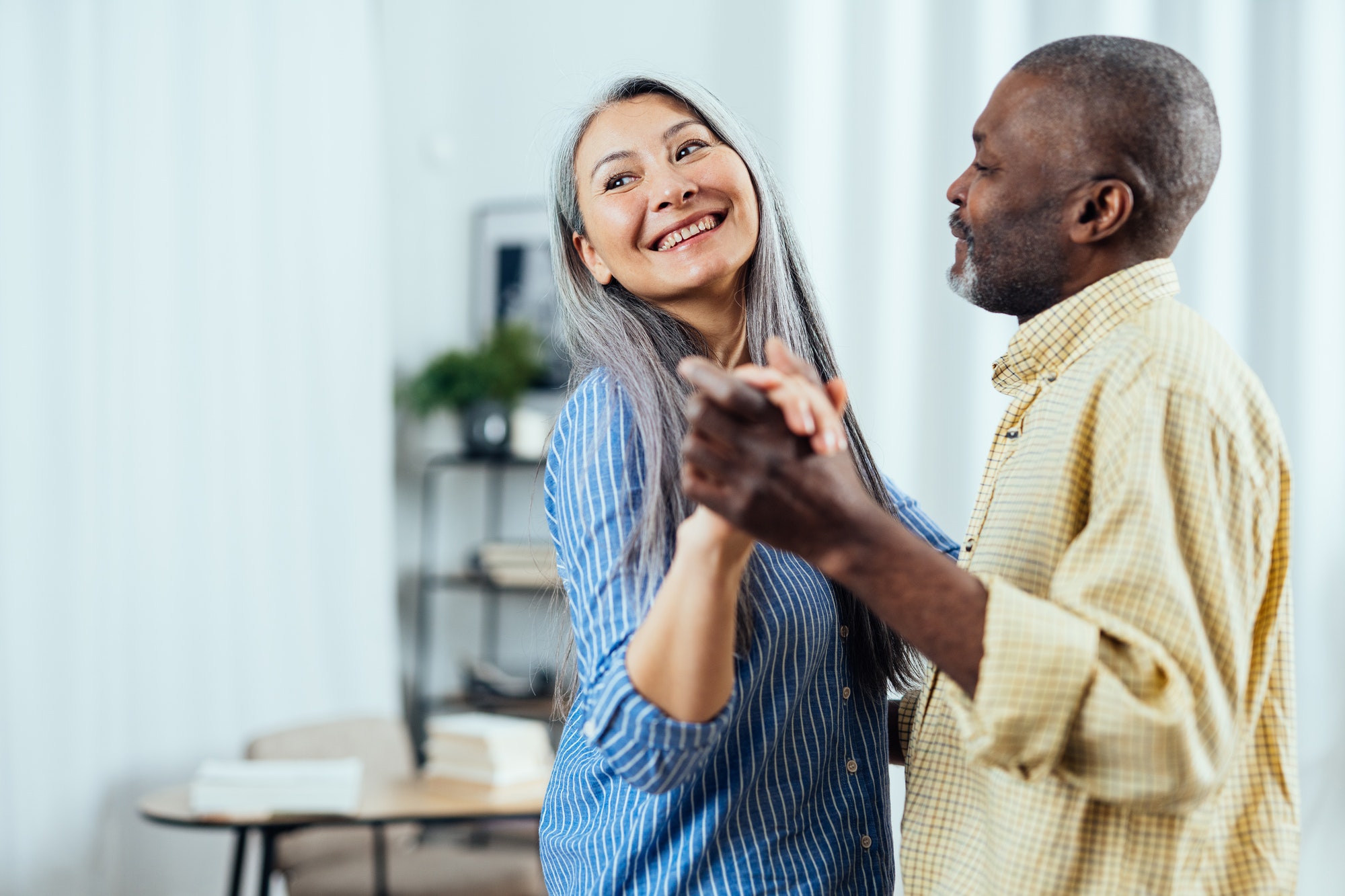 Senior couple dancing as they discuss their Medicare Savings Program.