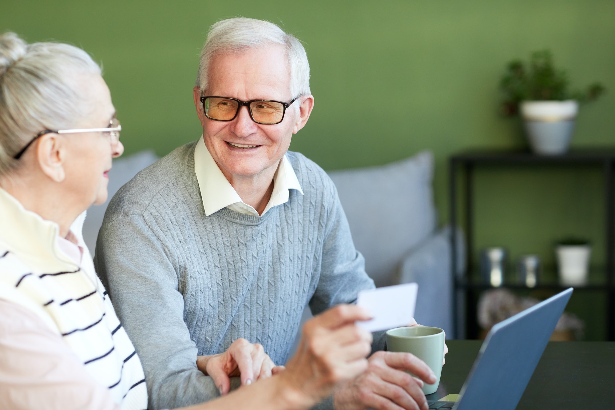 Happy senior man talking with his spouse about swing bed options in case they need it.