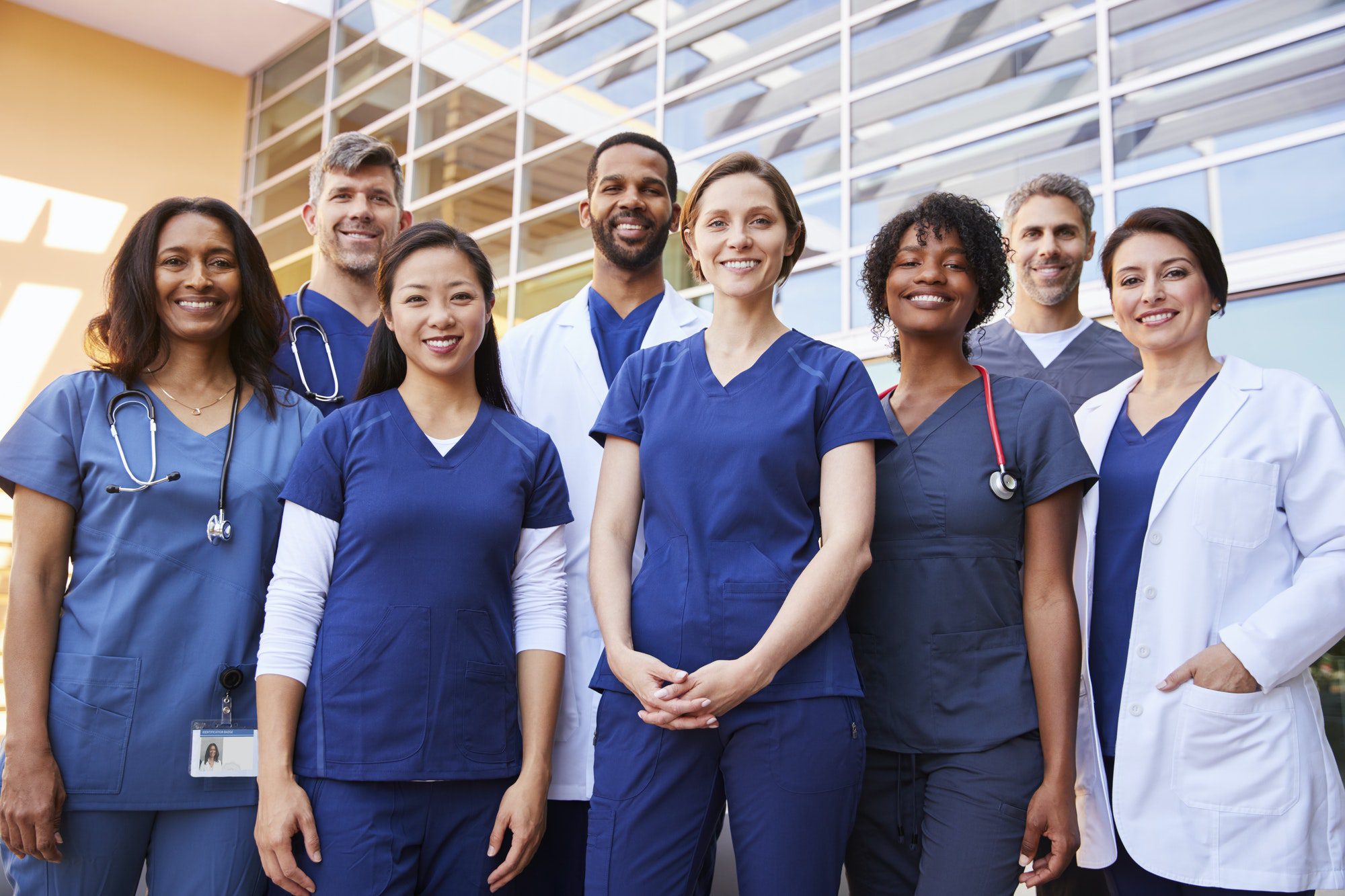 Smiling medical team standing together outside a hospital that takes Medicare in Arkansas